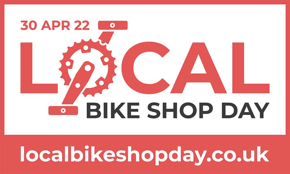 Image shows red and white text logo for local bike shop day. The O in local is a cog and pedals. The website at the bottom of the logo is: localbikeshopday.co.uk 