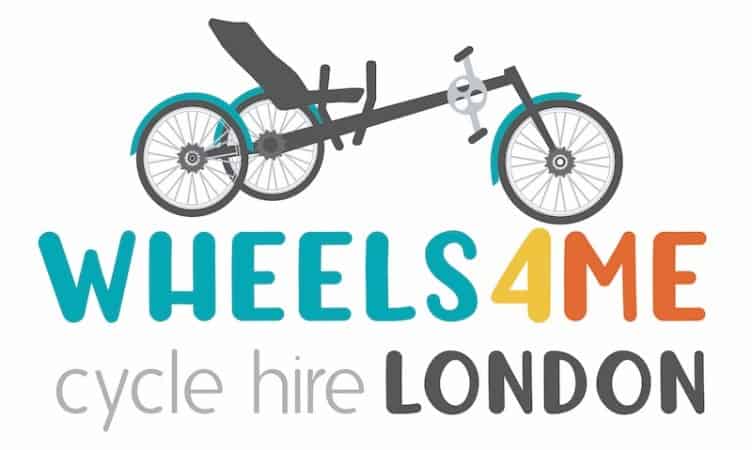 The Wheels for Me Logo, it's a brightly coloured text with a recumbent trike above it. 