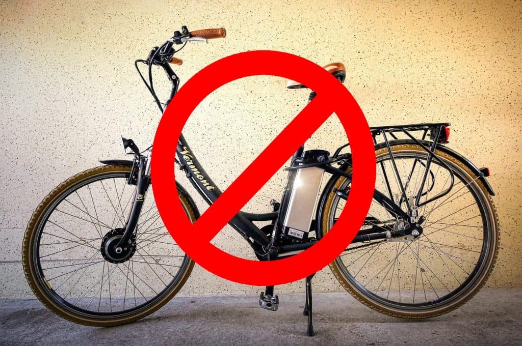 Pic of a modified e-bike with a red 'ban' symbol superimposed on it.