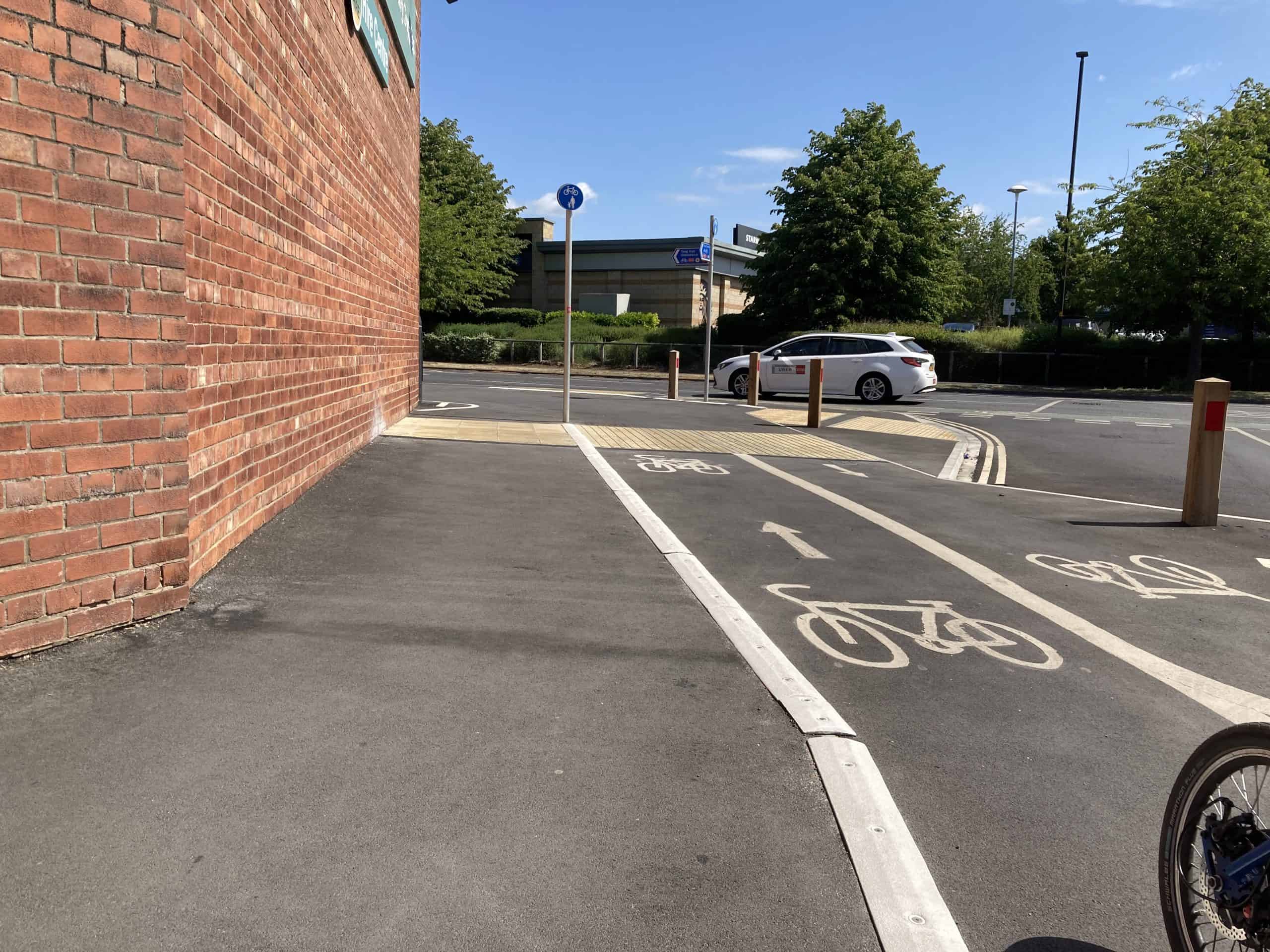A complex cycle track and pavement layout including junctions and a range of tactile paving and delineators.